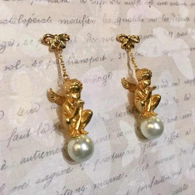 Cherub sitting on Pearl Earrings by Bill Skinner